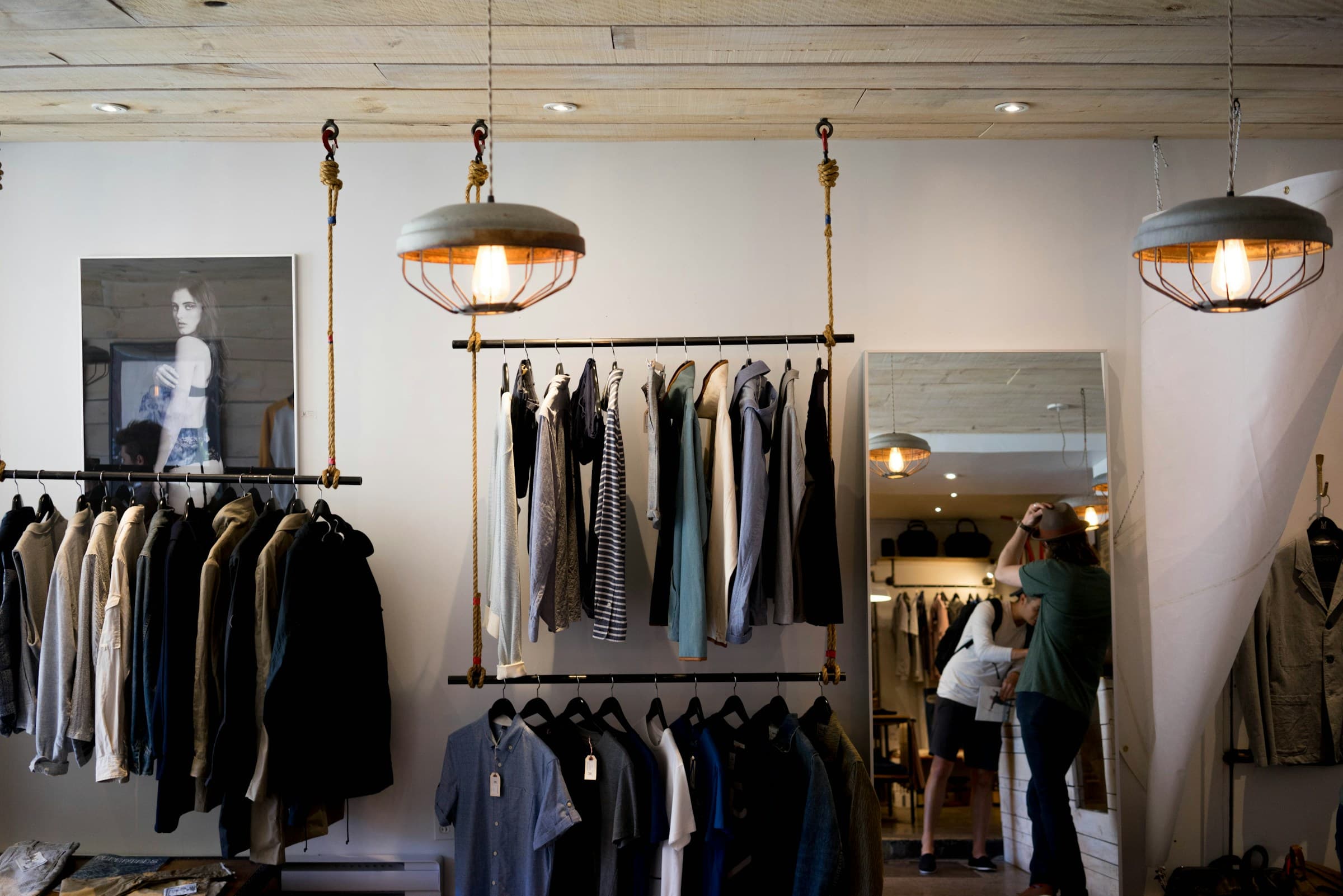 Timber ceiling and hanging garment rails in a clothing boutique.